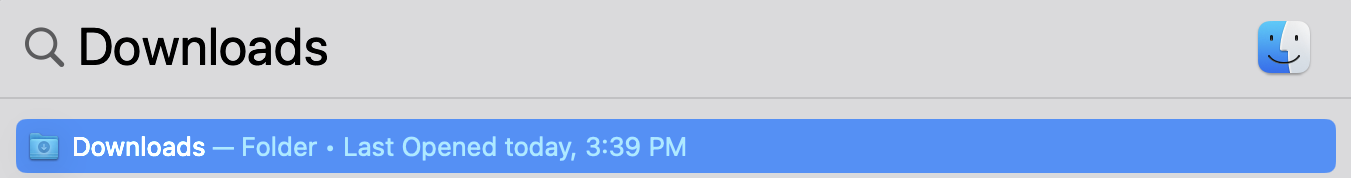 spotlight search with "downloads" typed into the search field